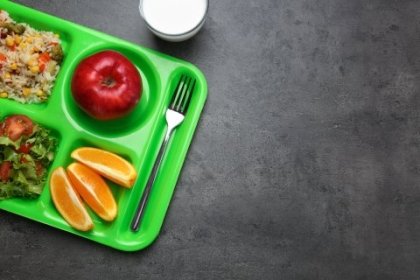 A lunch tray with fruit and vegetables